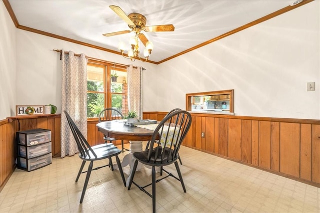 106 Emma Dr, Honea Path, SC 29654 - dining room with wainscoting, light flooring, wooden walls, crown molding, and a ceiling fan