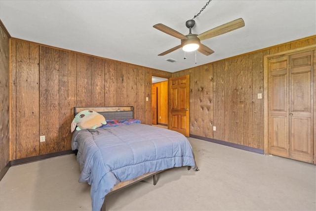 106 Emma Dr, Honea Path, SC 29654 - bedroom featuring wood walls, a ceiling fan, and concrete floors