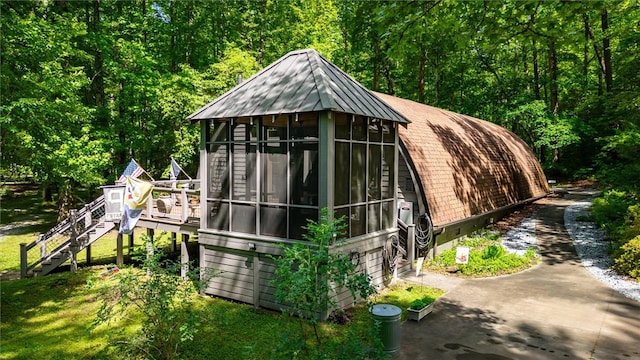1457 Cheohee Valley Rd, Tamassee, SC 29686 - view of outdoor structure with a sunroom, stairway, and a wooded view