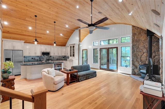 1457 Cheohee Valley Rd, Tamassee, SC 29686 - living room with wood ceiling, lofted ceiling, light wood-style floors, a wood stove, and ceiling fan