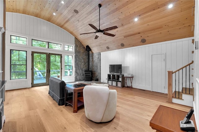 1457 Cheohee Valley Rd, Tamassee, SC 29686 - living room with a wood stove, wood ceiling, light wood-style floors, a ceiling fan, and healthy amount of natural light
