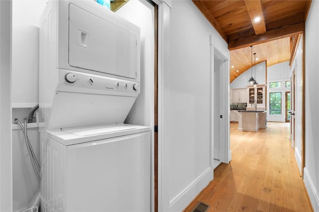 1457 Cheohee Valley Rd, Tamassee, SC 29686 - laundry area featuring wood ceiling, estacked washer and dryer, light wood-style floors, and baseboards