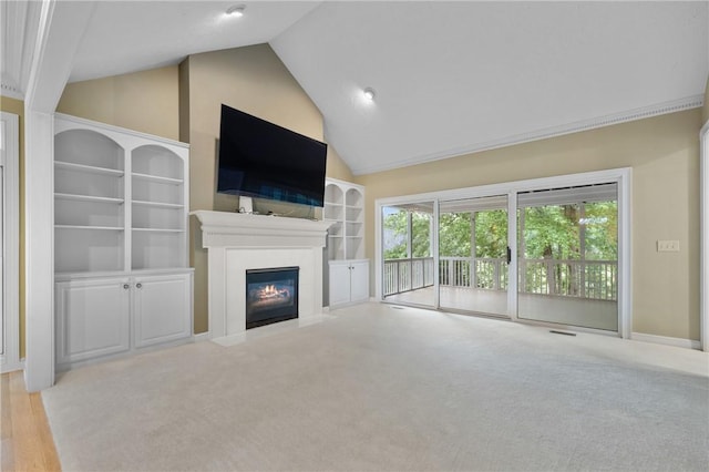 1029 Cross Creek Dr, Seneca, SC 29678 - unfurnished living room with lofted ceiling, a fireplace with flush hearth, built in shelves, baseboards, and carpet