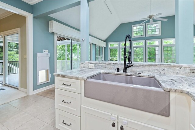 1029 Cross Creek Dr, Seneca, SC 29678 - kitchen featuring a sink, a ceiling fan, light stone countertops, white cabinets, and healthy amount of natural light