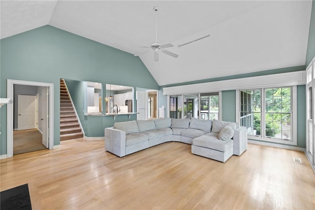 1029 Cross Creek Dr, Seneca, SC 29678 - living room featuring high vaulted ceiling, ceiling fan, light wood-style flooring, stairs, and baseboards