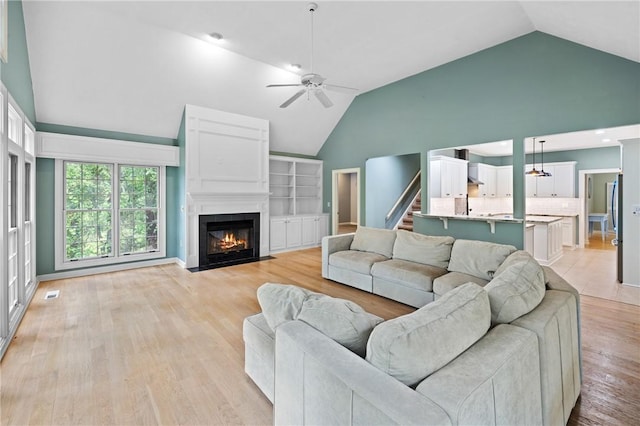 1029 Cross Creek Dr, Seneca, SC 29678 - living room with ceiling fan, light wood finished floors, a fireplace with flush hearth, and high vaulted ceiling