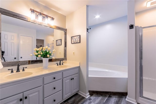 205 Shadow Oaks Dr, Easley, SC 29642 - bathroom featuring double vanity, a garden tub, wood finished floors, and a shower stall