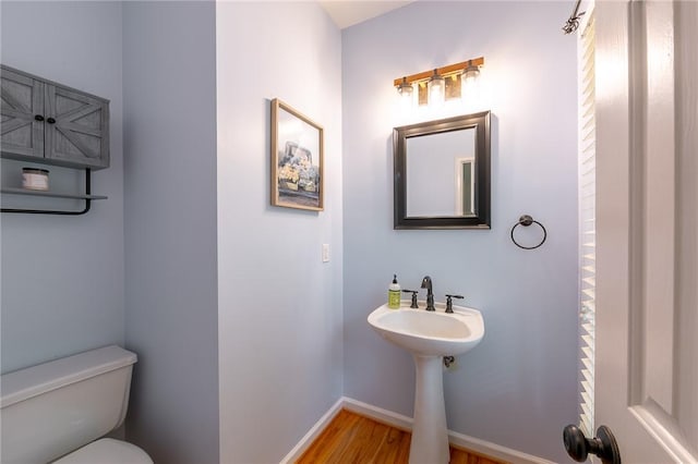 205 Shadow Oaks Dr, Easley, SC 29642 - half bathroom with toilet, wood finished floors, and baseboards