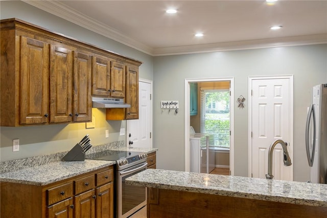 205 Shadow Oaks Dr, Easley, SC 29642 - kitchen with appliances with stainless steel finishes, under cabinet range hood, light stone countertops, ornamental molding, and brown cabinetry