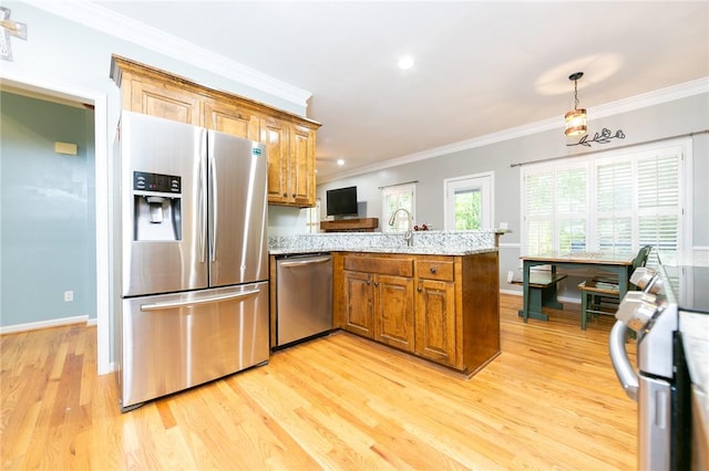 205 Shadow Oaks Dr, Easley, SC 29642 - kitchen featuring stainless steel appliances, a peninsula, brown cabinetry, ornamental molding, and light wood finished floors