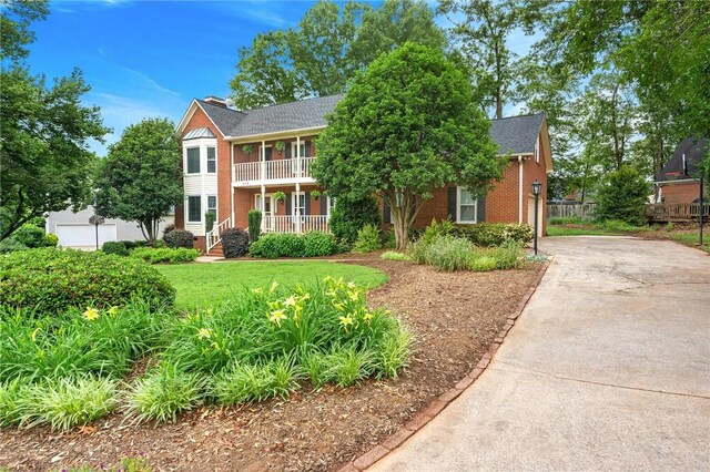 318 Chenoweth Dr, Simpsonville, SC 29681 - view of front of home featuring a porch, driveway, brick siding, and a balcony