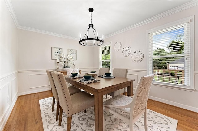 318 Chenoweth Dr, Simpsonville, SC 29681 - dining room with a chandelier, light wood-style floors, ornamental molding, and a wainscoted wall