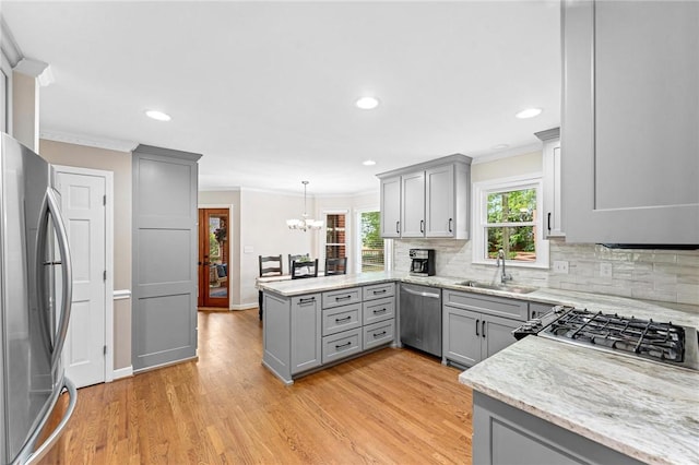 318 Chenoweth Dr, Simpsonville, SC 29681 - kitchen featuring gray cabinetry, stainless steel appliances, a sink, a peninsula, and crown molding