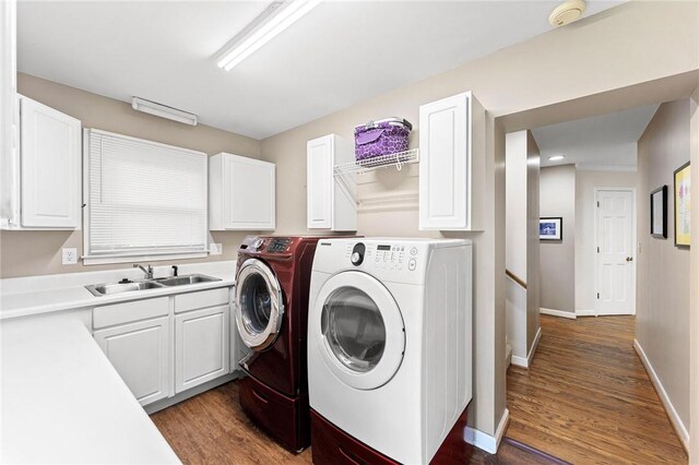 318 Chenoweth Dr, Simpsonville, SC 29681 - laundry room featuring independent washer and dryer, wood finished floors, baseboards, and cabinet space