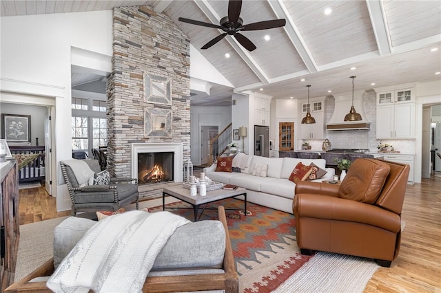 1819 Cross Creek Dr, Seneca, SC 29678 - living area featuring high vaulted ceiling, a stone fireplace, light wood-style flooring, a ceiling fan, and stairs