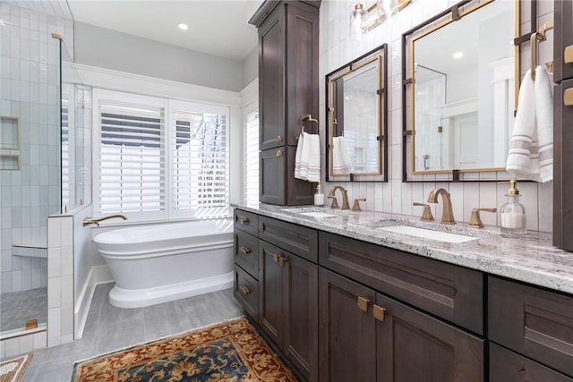 1819 Cross Creek Dr, Seneca, SC 29678 - bathroom featuring a freestanding tub, tiled shower, double vanity, and baseboards