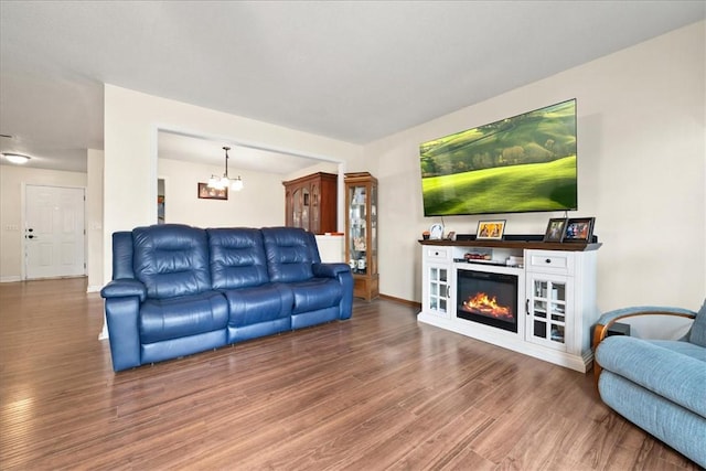 500 Concord Rd Unit A4, Anderson, SC 29621 - living room with wood finished floors, a chandelier, a glass covered fireplace, and baseboards