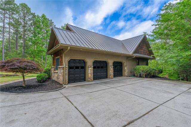 301 Augusta Way, Sunset, SC 29685 - view of side of property with a standing seam roof, stone siding, metal roof, and an attached garage