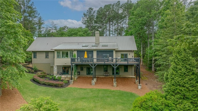 301 Augusta Way, Sunset, SC 29685 - back of property with a chimney, metal roof, a deck, and a lawn