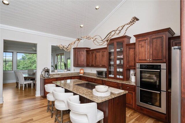 301 Augusta Way, Sunset, SC 29685 - kitchen with stainless steel double oven, a kitchen breakfast bar, light wood finished floors, a center island, and glass insert cabinets
