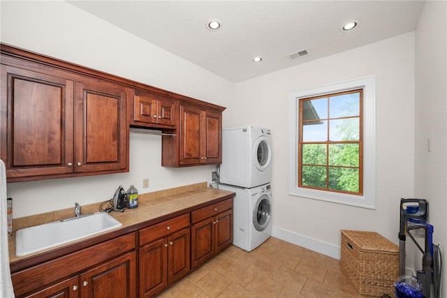 301 Augusta Way, Sunset, SC 29685 - laundry room featuring stacked washing machine and dryer, cabinet space, baseboards, recessed lighting, and light tile patterned flooring