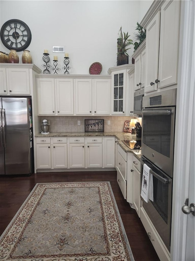 256 Chickadee Trl, Easley, SC 29642 - kitchen featuring stainless steel appliances, backsplash, white cabinetry, and glass insert cabinets