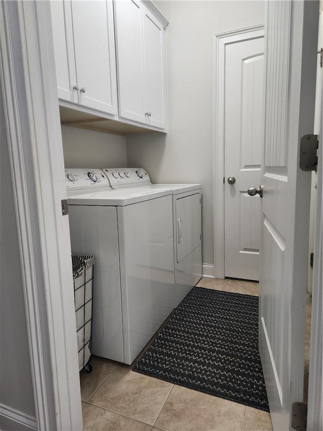 256 Chickadee Trl, Easley, SC 29642 - laundry area with washing machine and dryer, cabinet space, and light tile patterned floors