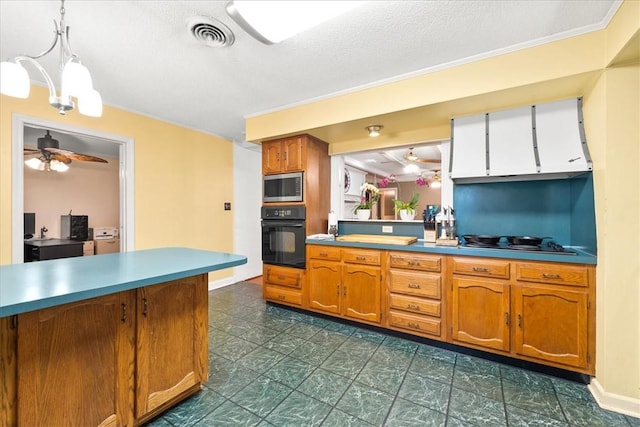 1122 Cox Rd, Anderson, SC 29621 - kitchen featuring black appliances, brown cabinetry, decorative light fixtures, a textured ceiling, and a ceiling fan