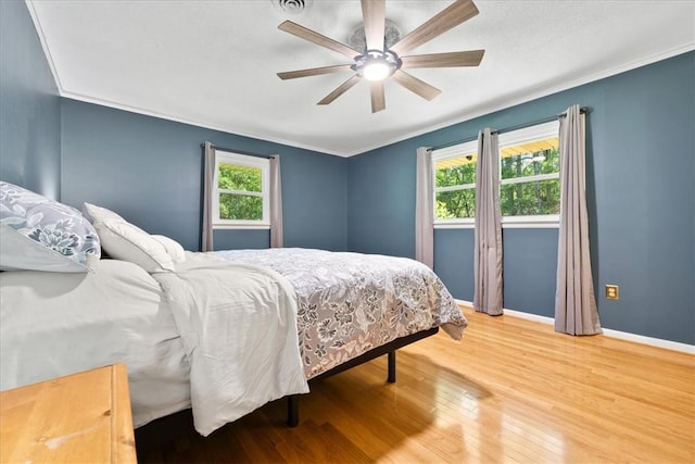 1122 Cox Rd, Anderson, SC 29621 - bedroom with multiple windows, wood finished floors, baseboards, ornamental molding, and ceiling fan