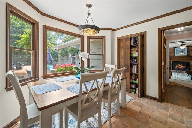 109 Cameron Way, Anderson, SC 29621 - dining room with stone finish flooring, crown molding, baseboards, and a fireplace