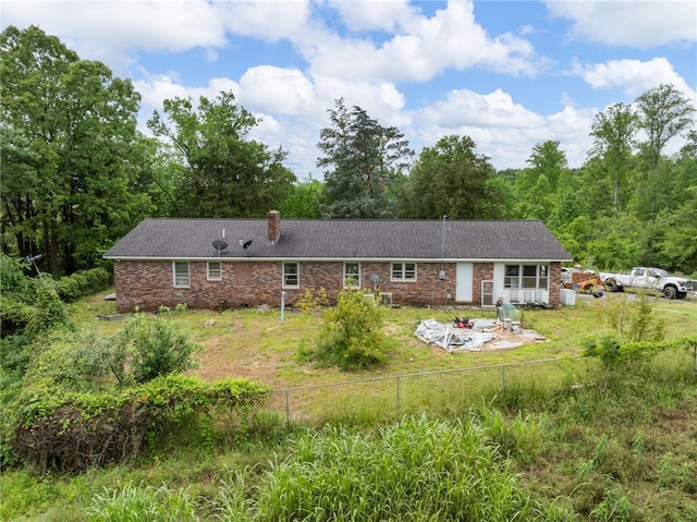 1225 Dogwood Ln, Clinton, SC 29325 - rear view of house featuring an outdoor fire pit, brick siding, a chimney, and a view of trees