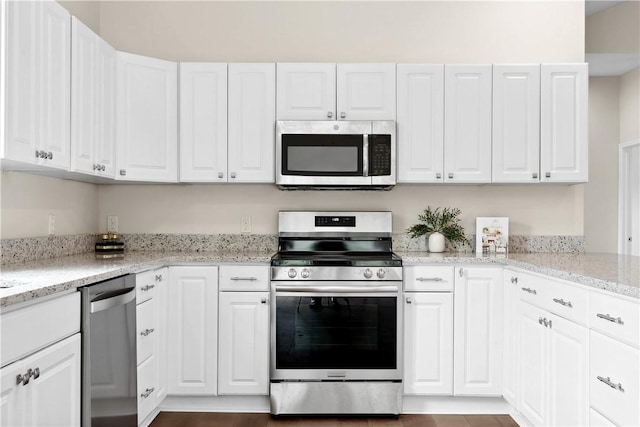 1316 E S 6th St, Seneca, SC 29678 - kitchen featuring appliances with stainless steel finishes, white cabinets, and light stone counters