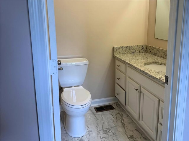 1316 E S 6th St, Seneca, SC 29678 - bathroom with marble finish floors, vanity, toilet, and baseboards