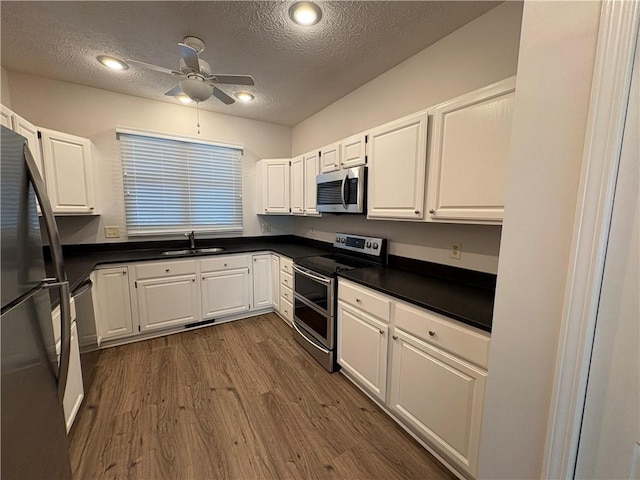 495 Tall Ship Dr Unit 340, Salem, SC 29676 - kitchen featuring stainless steel appliances, a sink, a textured ceiling, dark countertops, and dark wood-type flooring