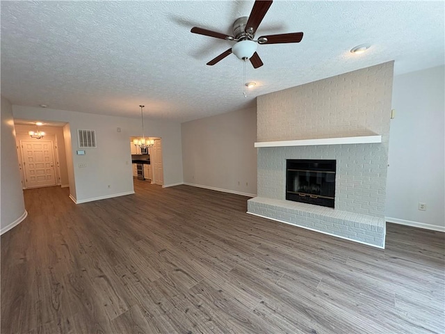 495 Tall Ship Dr Unit 340, Salem, SC 29676 - unfurnished living room featuring a fireplace, a chandelier, a textured ceiling, wood finished floors, and ceiling fan