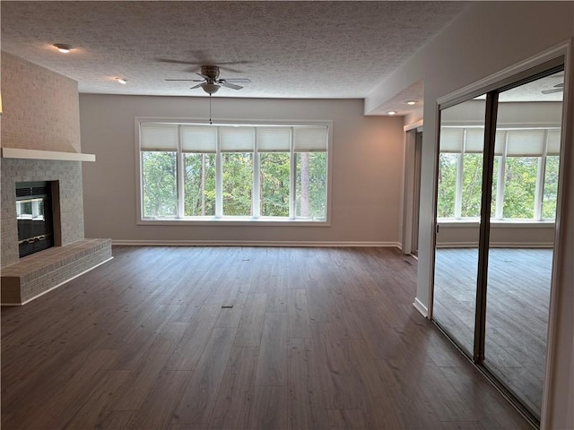 495 Tall Ship Dr Unit 340, Salem, SC 29676 - unfurnished living room with a ceiling fan, a textured ceiling, wood finished floors, baseboards, and a fireplace
