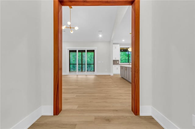 120 Thomason View Rd, Fountain Inn, SC 29644 - hallway with light wood-type flooring, a chandelier, and baseboards