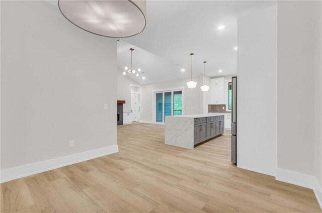 120 Thomason View Rd, Fountain Inn, SC 29644 - kitchen featuring light countertops, light wood-type flooring, open floor plan, a kitchen island, and pendant lighting