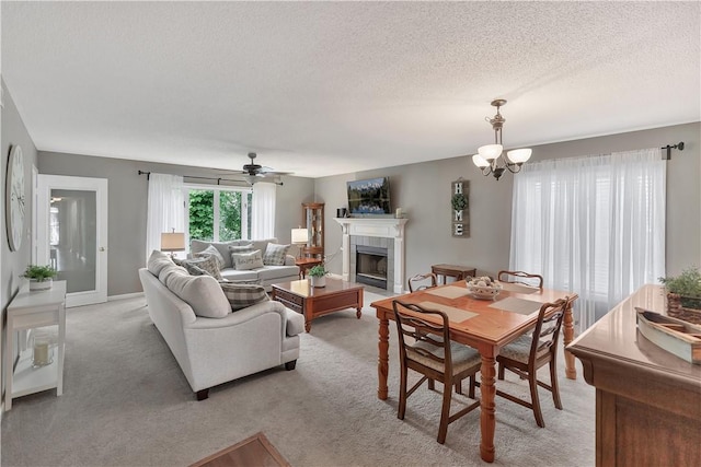 312 Northlake Dr, Anderson, SC 29625 - living room with a tile fireplace, a textured ceiling, light carpet, a chandelier, and a ceiling fan
