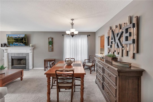 312 Northlake Dr, Anderson, SC 29625 - dining area with a chandelier, light colored carpet, a textured ceiling, and a tiled fireplace