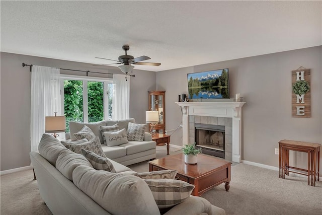 312 Northlake Dr, Anderson, SC 29625 - living room with light colored carpet, ceiling fan, a fireplace, and a textured ceiling