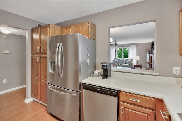 312 Northlake Dr, Anderson, SC 29625 - kitchen featuring appliances with stainless steel finishes, light countertops, a ceiling fan, and light wood-style floors