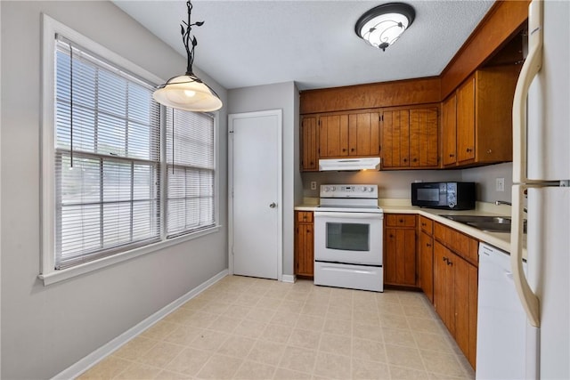 13036 W Camelia Ln, Seneca, SC 29678 - kitchen featuring white appliances, under cabinet range hood, brown cabinets, light countertops, and a sink
