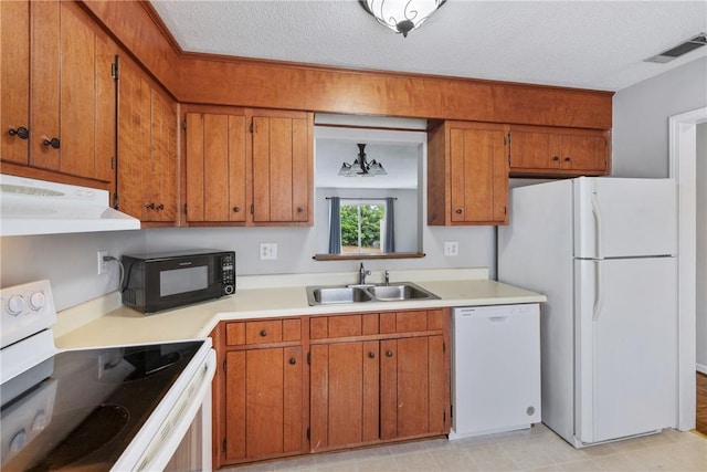 13036 W Camelia Ln, Seneca, SC 29678 - kitchen with white appliances, a sink, under cabinet range hood, brown cabinets, and light countertops