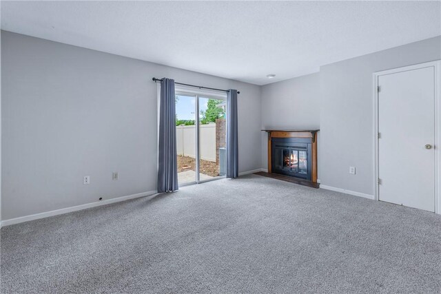 13036 W Camelia Ln, Seneca, SC 29678 - unfurnished living room featuring a fireplace with flush hearth, carpet, and baseboards