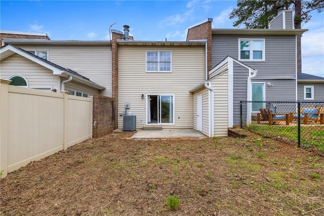 13036 W Camelia Ln, Seneca, SC 29678 - back of property with a patio area, a chimney, a fenced backyard, and central AC unit