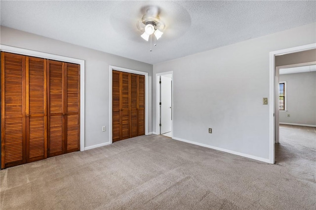 13036 W Camelia Ln, Seneca, SC 29678 - unfurnished bedroom with two closets, carpet flooring, baseboards, and a textured ceiling
