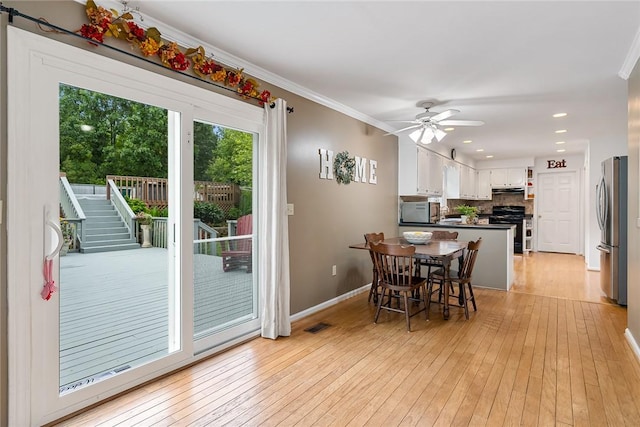 101 Long View Ln, Pickens, SC 29671 - dining space featuring light wood-style flooring, baseboards, ornamental molding, ceiling fan, and stairway