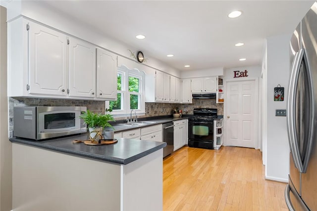 101 Long View Ln, Pickens, SC 29671 - kitchen with appliances with stainless steel finishes, a sink, under cabinet range hood, dark countertops, and white cabinetry