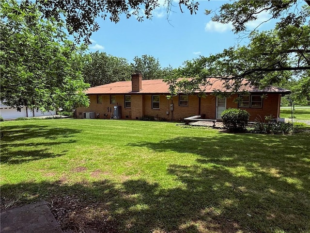 308 Oak Drive Ext, Honea Path, SC 29654 - back of property featuring a yard, a chimney, brick siding, and central AC unit